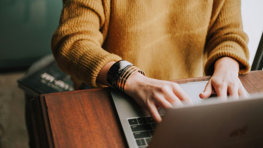 A person typing on a laptop.